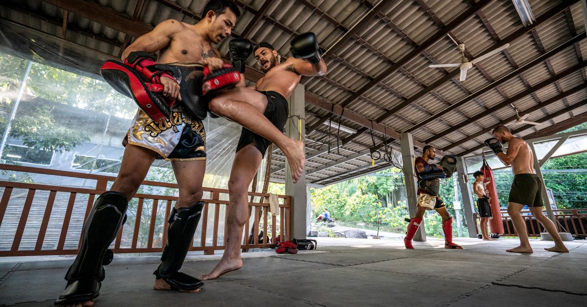 Muay Thai fighters training during a camp in Thailand with world-class coaches and international participants.
